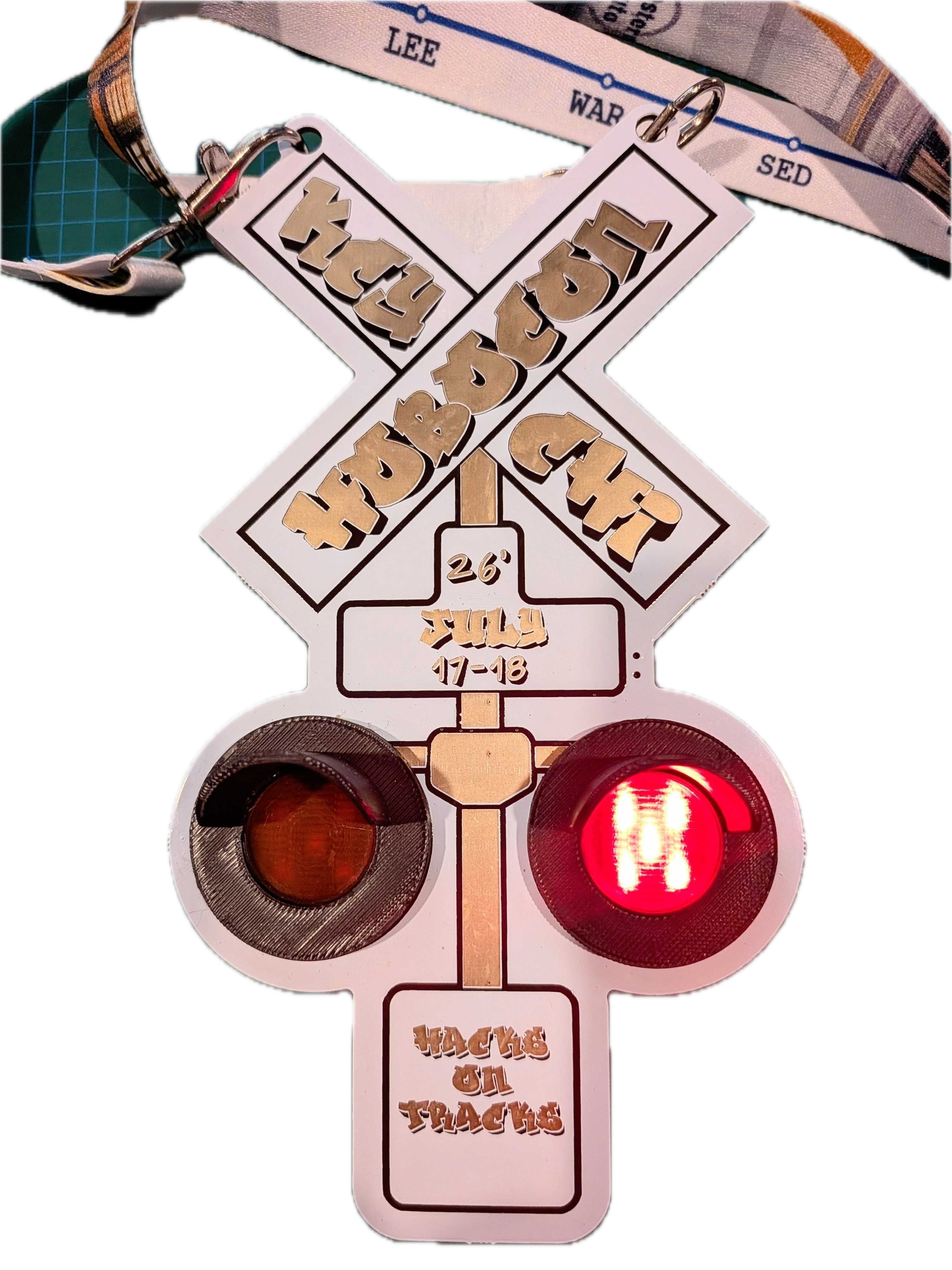 Hobocon badge shaped like a railroad crossing signal with a glowing red light