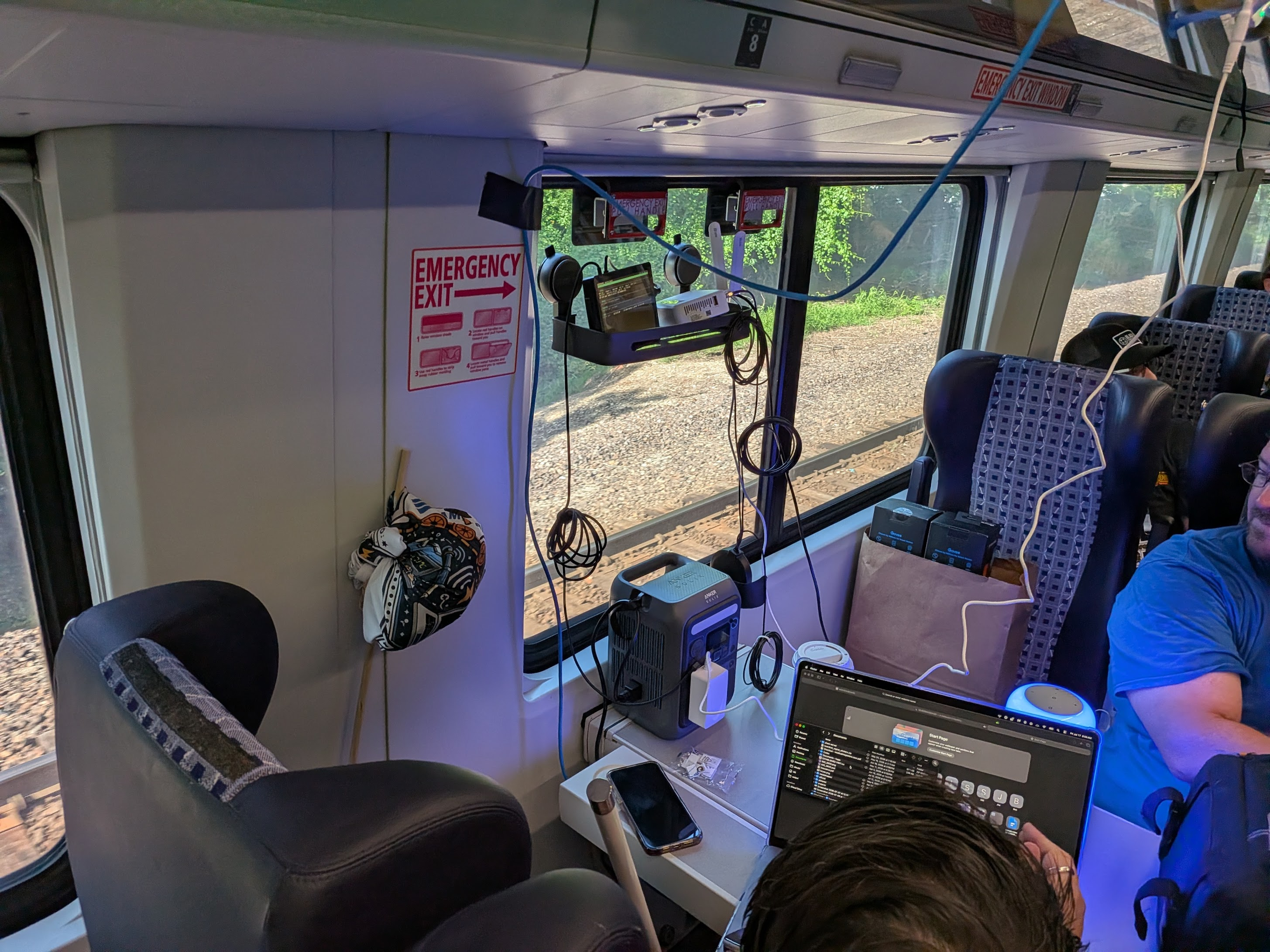 Network equipment, ethernet cables, and a portable power station beside the train window