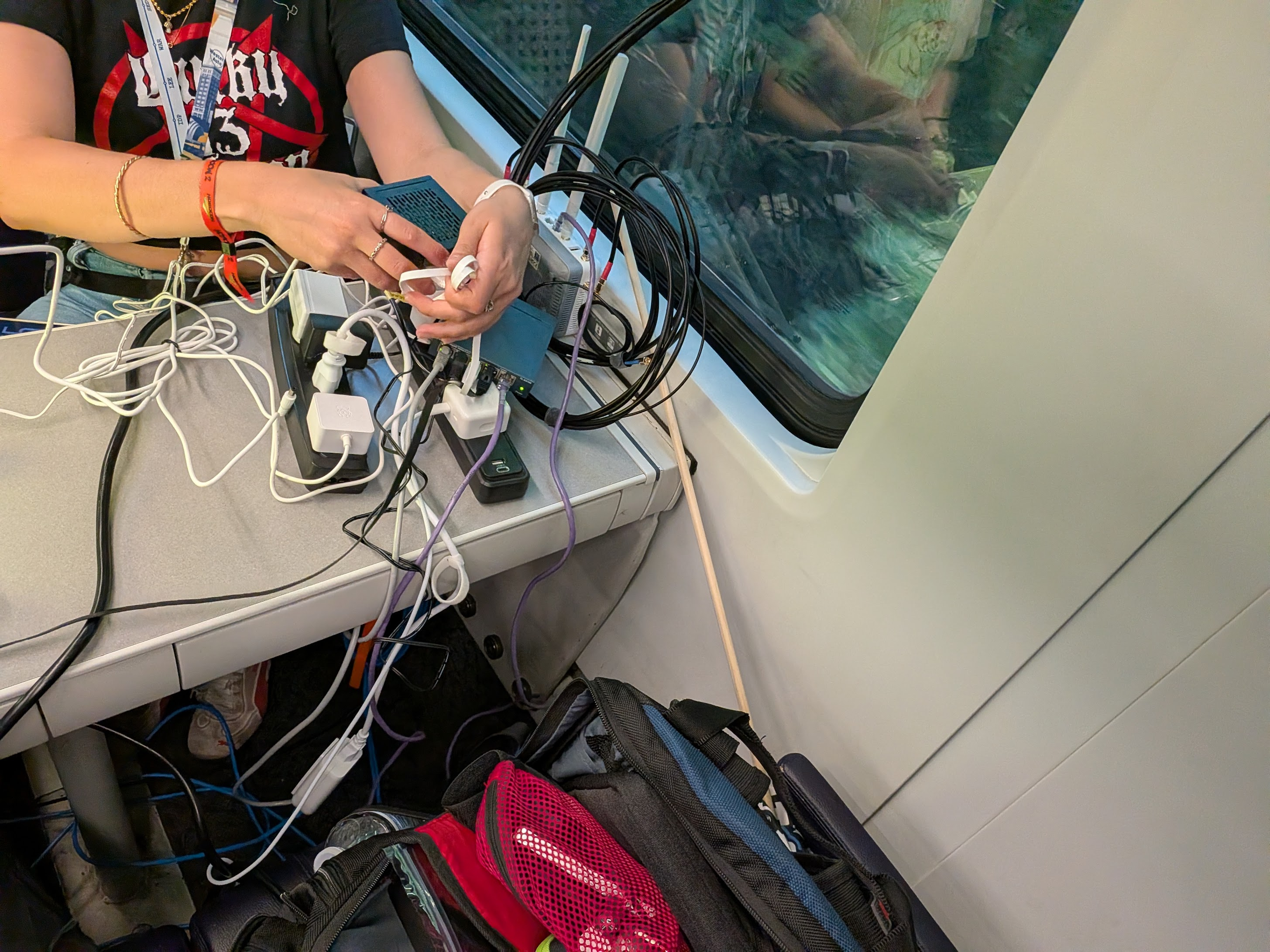 Power strips, adapters, and network cables covering the corner of a train table